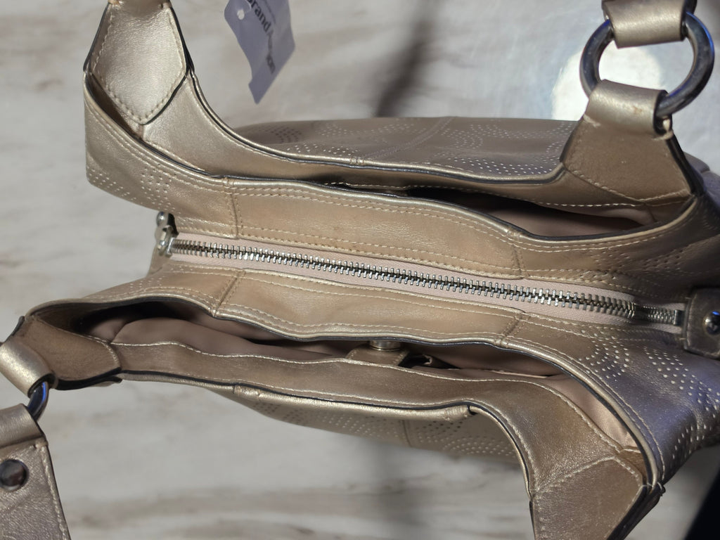 The Gettin Place metallic gold leather Coach shoulder bag with perforated signature pattern and top-zip closure.